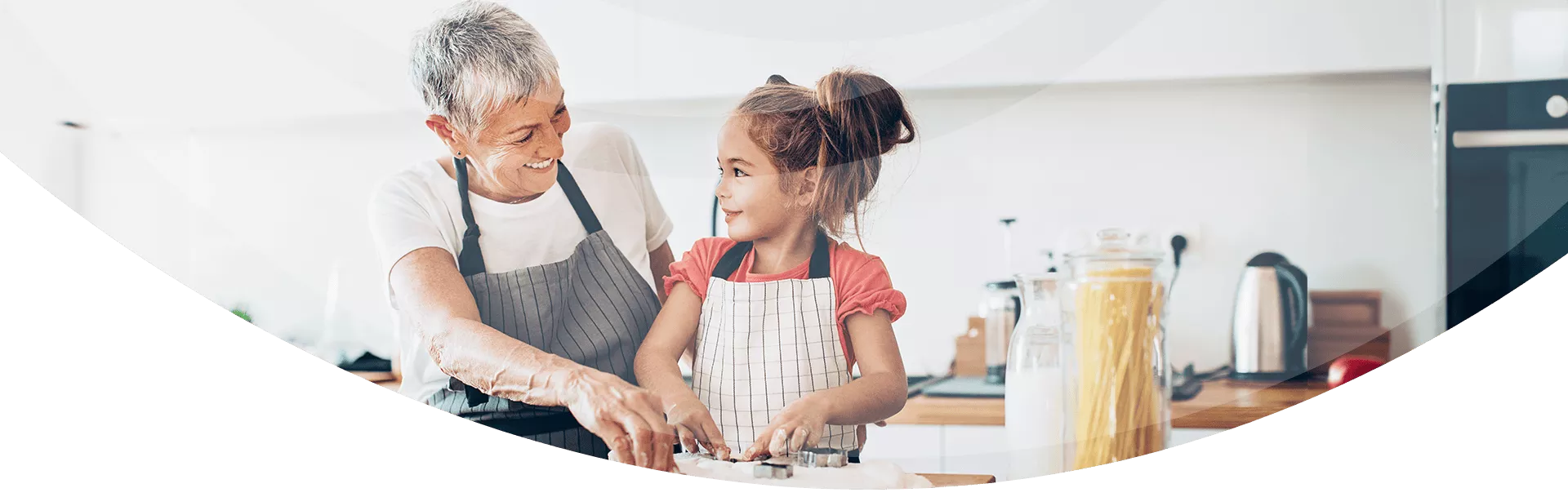 grandmother cooking with granddaughter