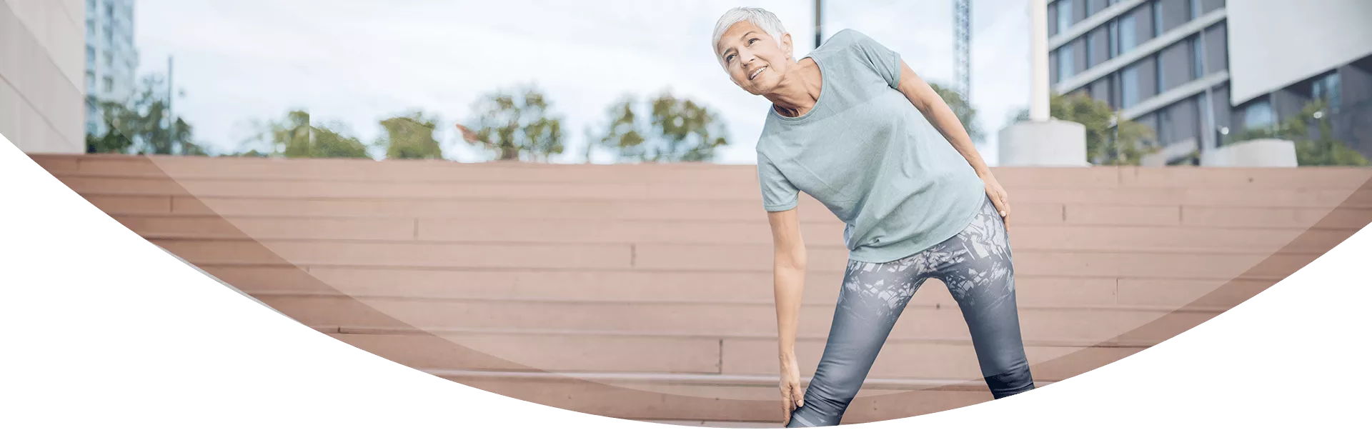 older woman stretching outdoors