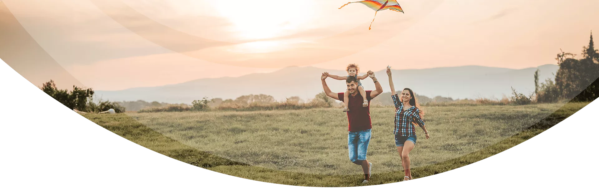 young family flying a kite together