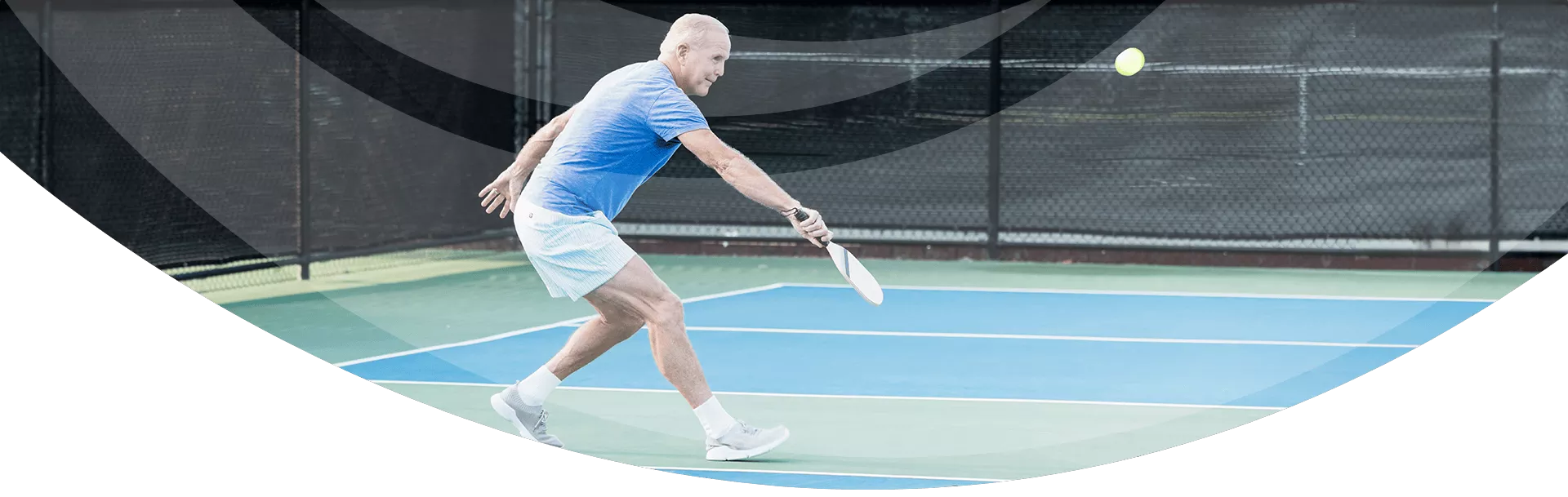 senior man playing pickleball