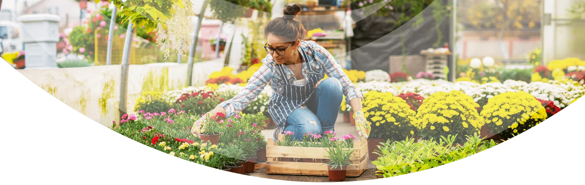 woman kneeling in greenhouse